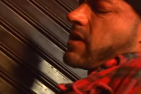 homosexual hammering in front of the road signs